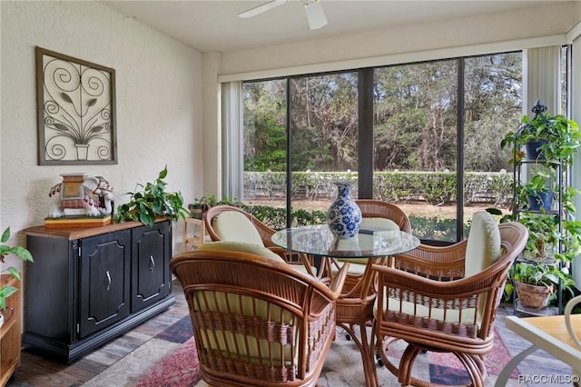 sunroom / solarium featuring ceiling fan