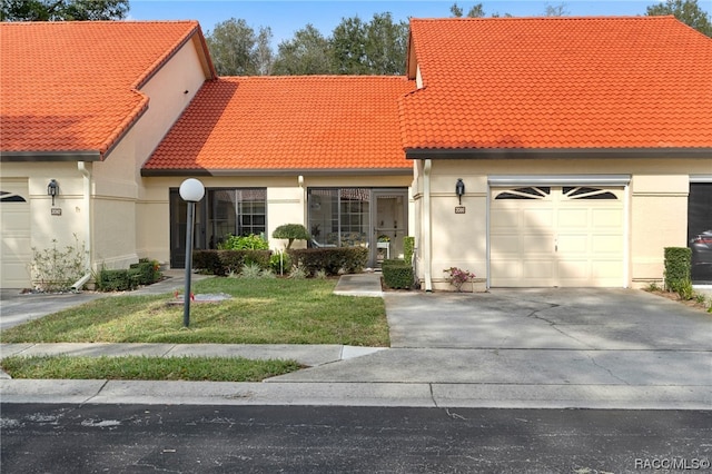 view of front of house with a garage and a front lawn