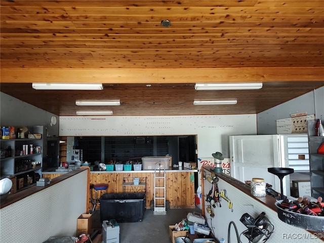 kitchen featuring wooden ceiling and concrete flooring