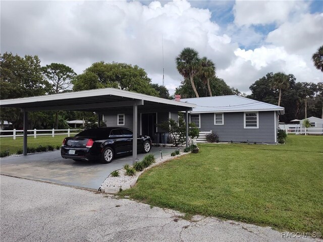 view of front facade featuring a front lawn and a carport