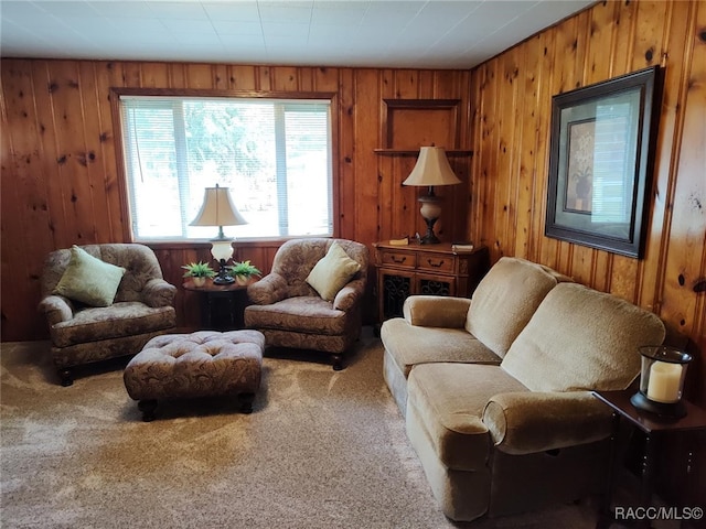 living room featuring carpet flooring and wood walls