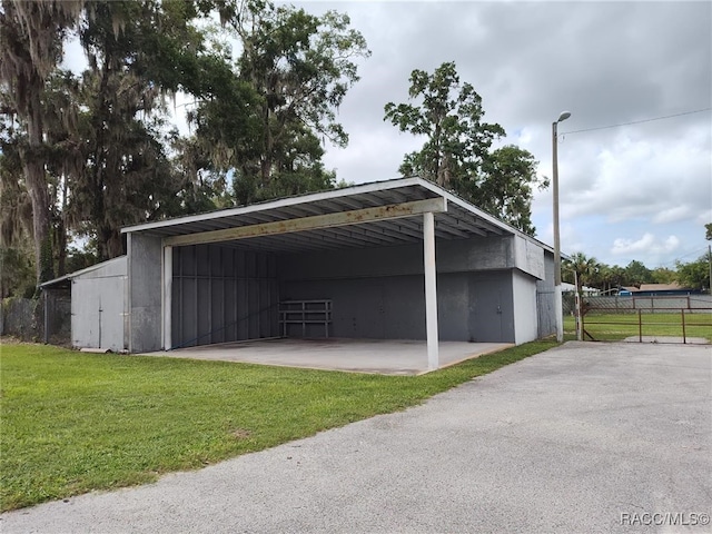 view of parking / parking lot featuring a yard