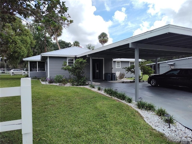 view of front of property featuring a front yard and a carport