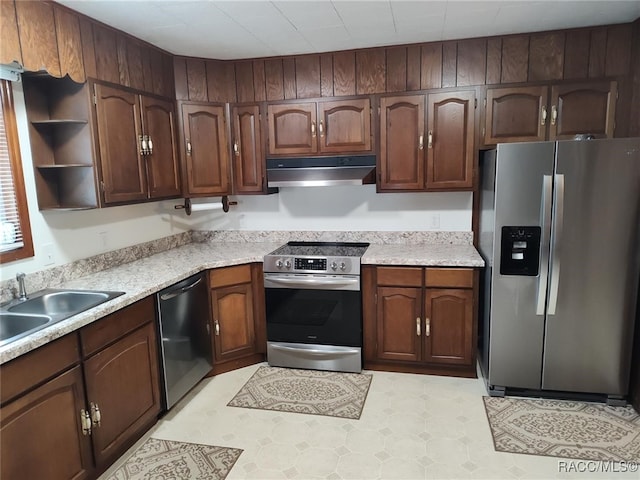 kitchen with appliances with stainless steel finishes and dark brown cabinetry