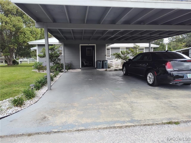 view of car parking with a carport and a lawn