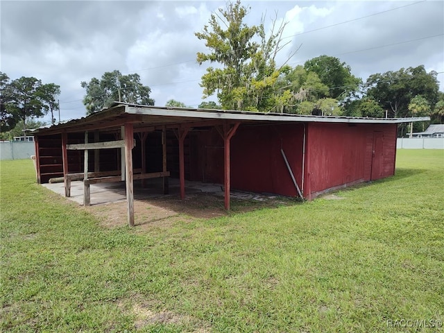 view of outbuilding featuring a yard