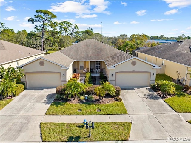 ranch-style house featuring a front yard and a garage