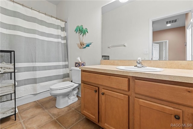 bathroom featuring tile patterned flooring, vanity, and toilet