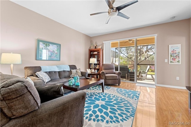 living room featuring ceiling fan and light hardwood / wood-style flooring