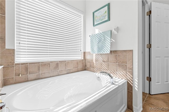 bathroom featuring a washtub and tile patterned flooring