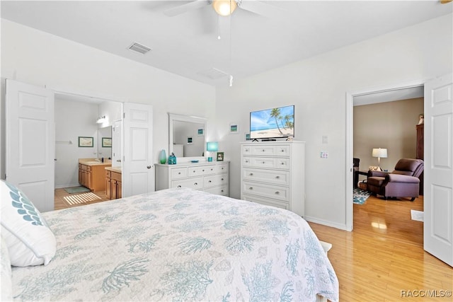 bedroom featuring connected bathroom, light hardwood / wood-style floors, and ceiling fan