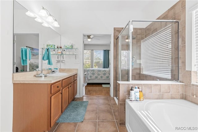 bathroom with ceiling fan, tile patterned flooring, vanity, and shower with separate bathtub