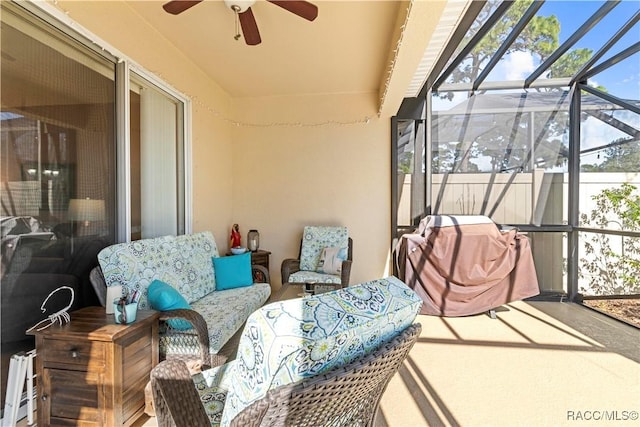 sunroom / solarium featuring ceiling fan and baseboard heating