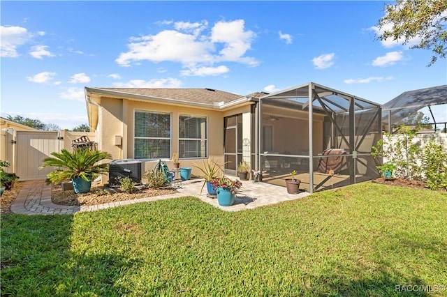 rear view of house featuring a patio area, a yard, and central AC