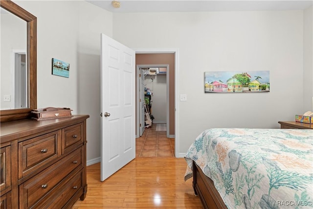 bedroom with light hardwood / wood-style flooring and a closet