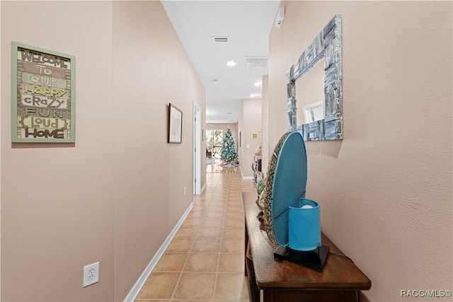 hall featuring light tile patterned floors