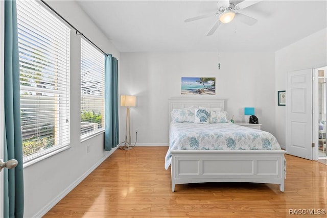 bedroom with ceiling fan and light hardwood / wood-style floors