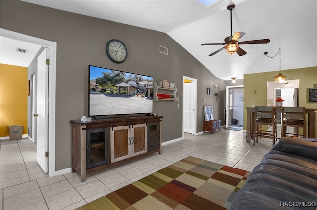 tiled living room featuring ceiling fan and lofted ceiling