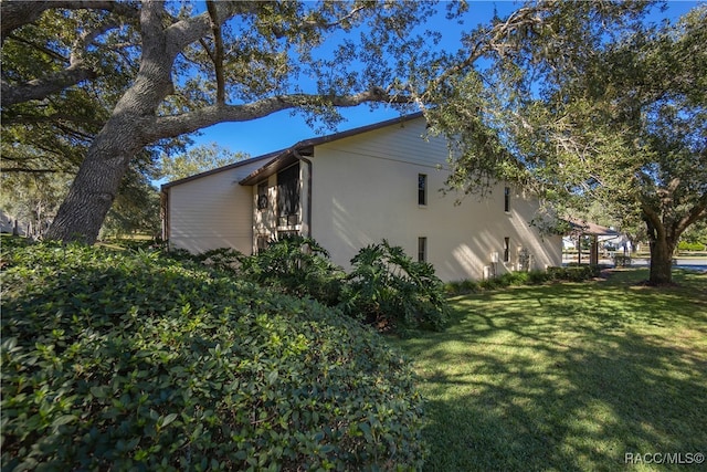 view of home's exterior featuring a lawn