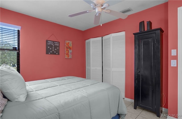 tiled bedroom featuring a closet and ceiling fan