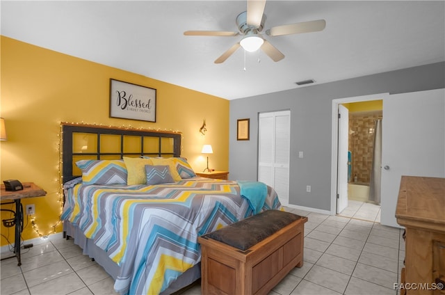 tiled bedroom with ensuite bath, a closet, and ceiling fan