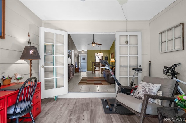 interior space with hardwood / wood-style floors, ceiling fan, lofted ceiling, and ornamental molding