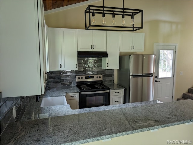 kitchen featuring white cabinets, kitchen peninsula, stainless steel appliances, and tasteful backsplash