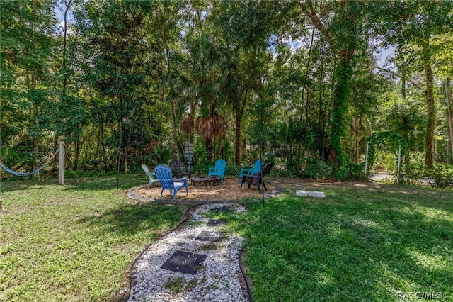 view of yard with a fire pit