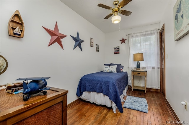 bedroom with ceiling fan and dark hardwood / wood-style flooring