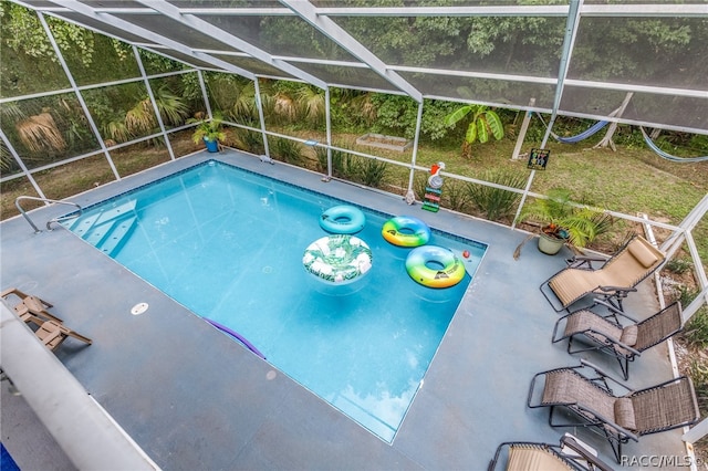 view of pool with a patio and a lanai