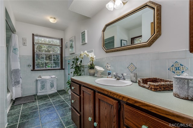 bathroom with tile patterned floors, shower / tub combination, vanity, and tile walls