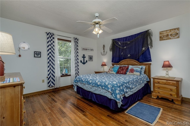 bedroom featuring a textured ceiling, dark hardwood / wood-style flooring, and ceiling fan