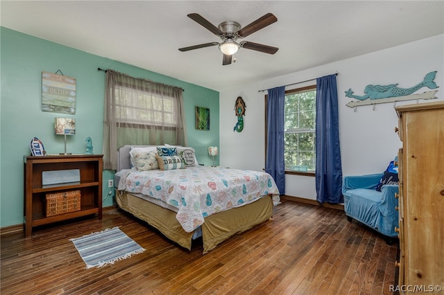 bedroom with ceiling fan and dark wood-type flooring