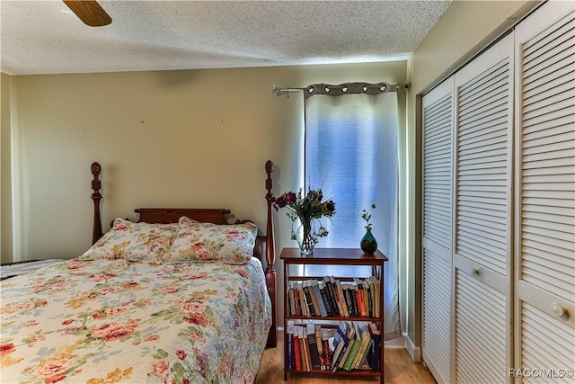 bedroom featuring a closet, a textured ceiling, and wood finished floors