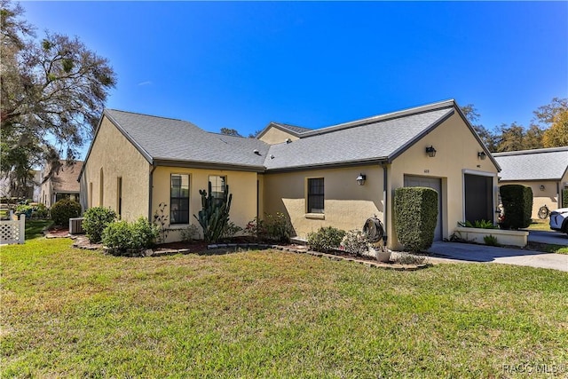 exterior space with a garage, a front lawn, concrete driveway, and stucco siding