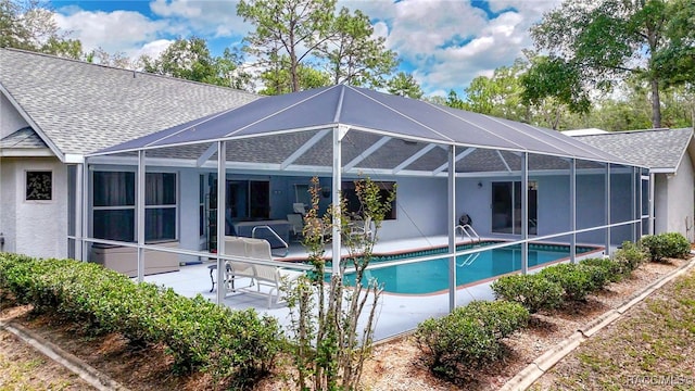 1150 E Cleveland St, Hernando, FL 34442 - back of house with a shingled roof, a patio area, stucco siding, a lanai, and an outdoor pool
