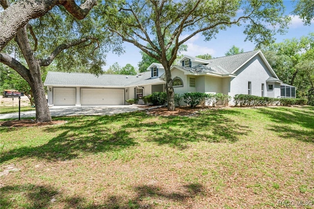 1150 E Cleveland St, Hernando, FL 34442 - view of front of house with a garage, stucco siding, a front yard, and driveway