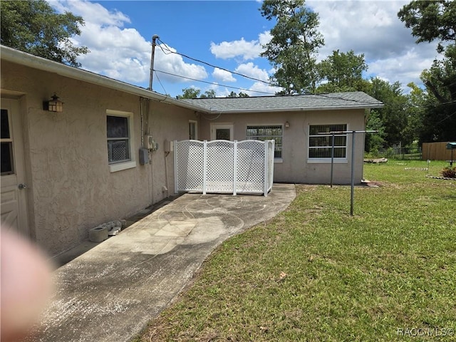 215 S Jefferson St, Beverly Hills, FL 34465 - back of house with stucco siding and a patio area