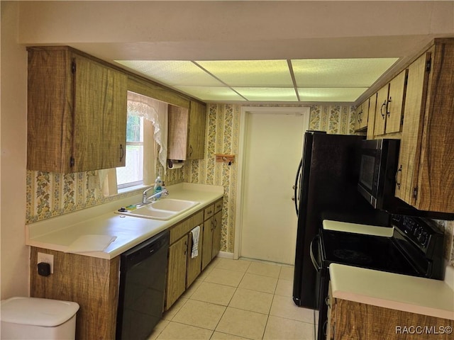 215 S Jefferson St, Beverly Hills, FL 34465 - kitchen with black appliances, wallpapered walls, light countertops, light tile patterned flooring, and brown cabinets