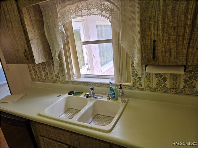 215 S Jefferson St, Beverly Hills, FL 34465 - kitchen with dishwasher, light countertops, and wallpapered walls
