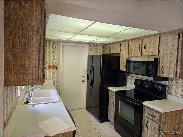 215 S Jefferson St, Beverly Hills, FL 34465 - kitchen featuring black appliances, light tile patterned flooring, light countertops, and wallpapered walls