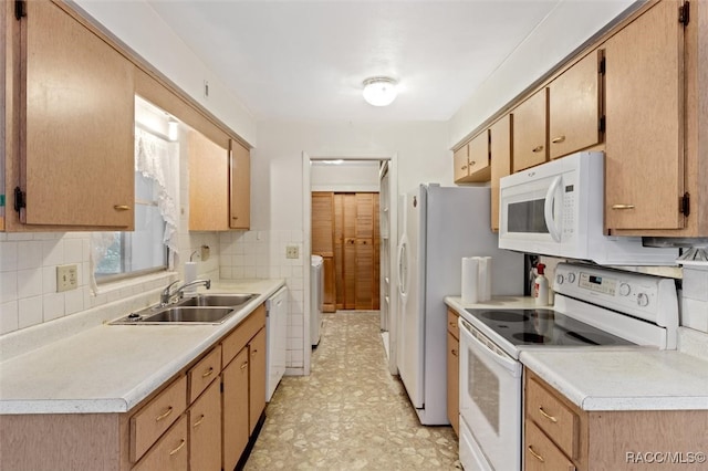 kitchen featuring washer / clothes dryer, decorative backsplash, sink, and white appliances