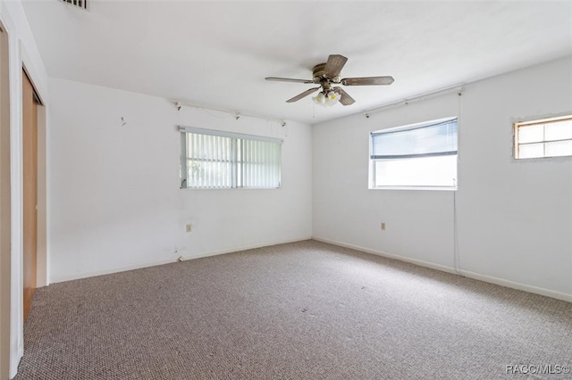 unfurnished room with ceiling fan and carpet floors