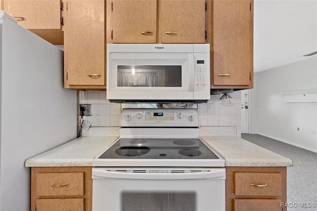 kitchen featuring decorative backsplash and white appliances