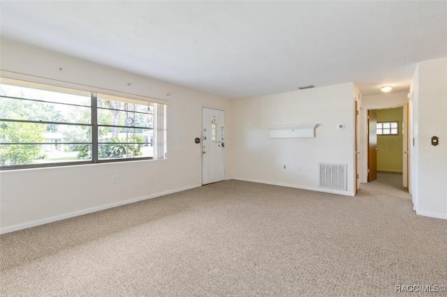 spare room with light carpet