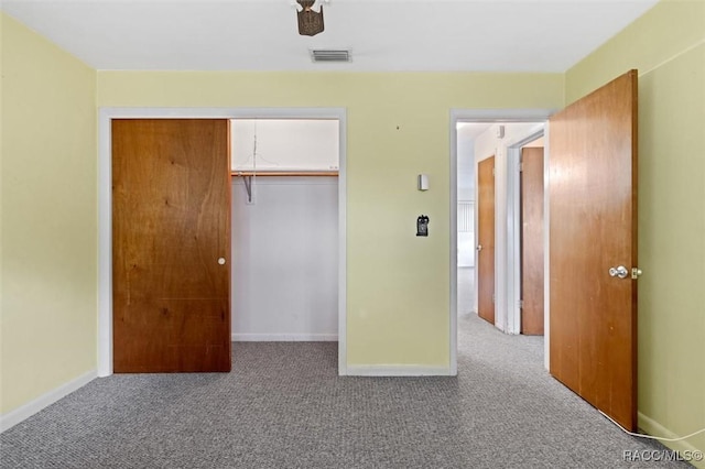 unfurnished bedroom with carpet flooring, a closet, and ceiling fan