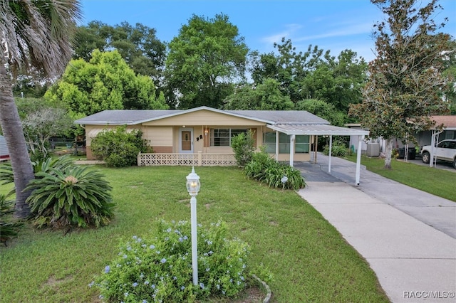 single story home with a carport, covered porch, and a front lawn