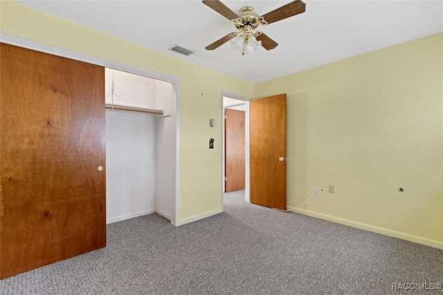 unfurnished bedroom with carpet, a closet, and ceiling fan