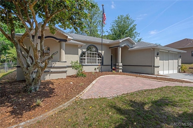 483 N Turkey Pine Loop, Lecanto, FL 34461 - view of front of property featuring fence, concrete driveway, stucco siding, and a garage