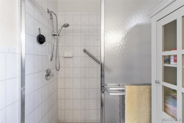 bathroom with a shower with shower door